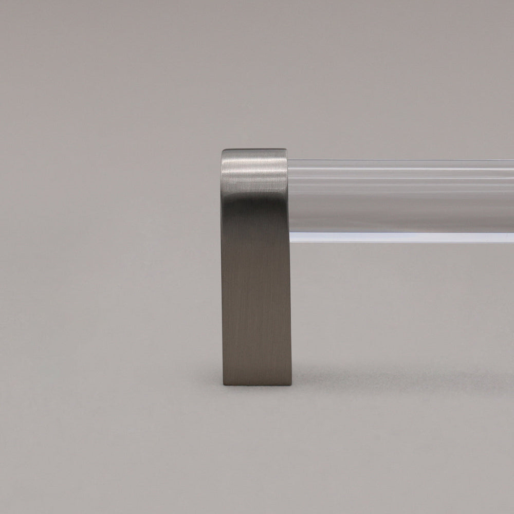 close up of clear and satin nickel cabinet pull stem on gray background