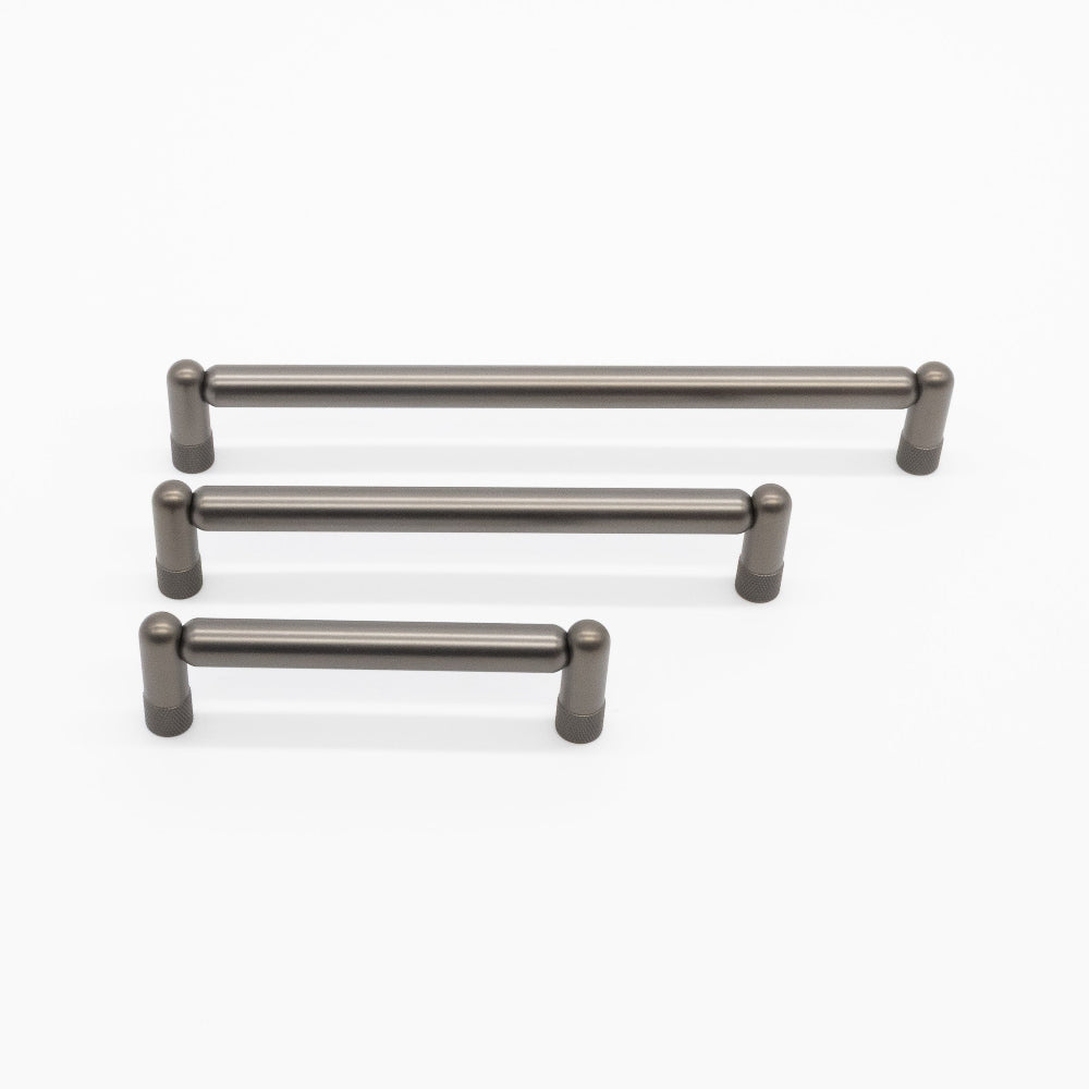 three sizes of graphite knurled cabinet pulls on white background