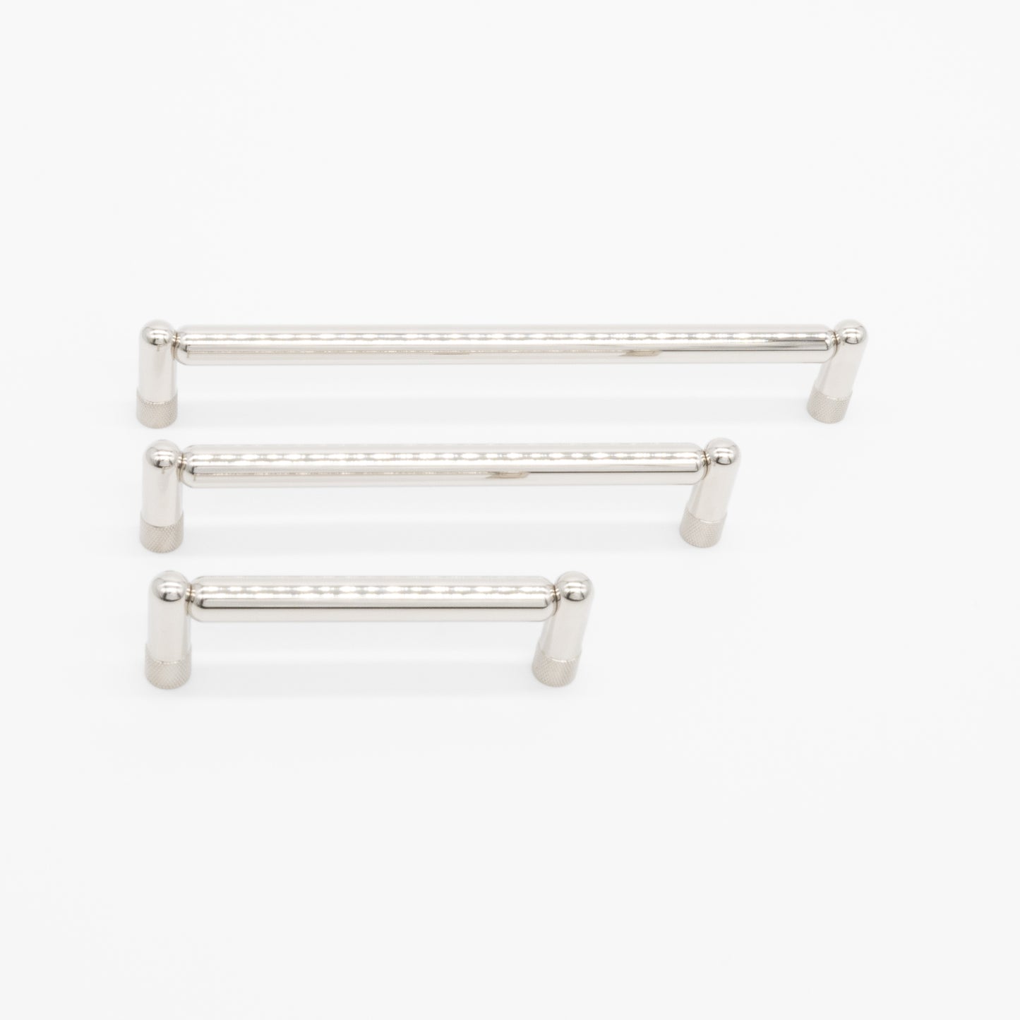 three sizes of polished nickel knurled pull on a white background
