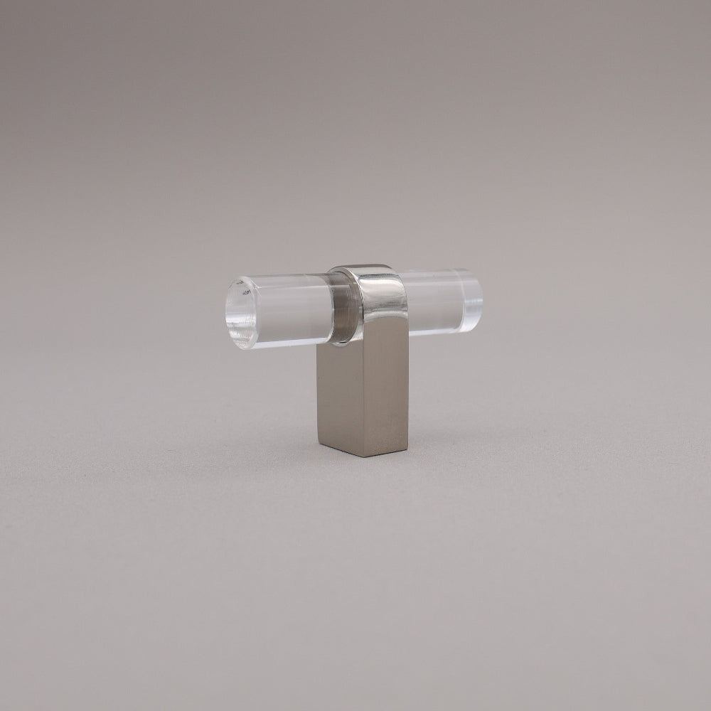 Polished nickel and acrylic knob against a gray background