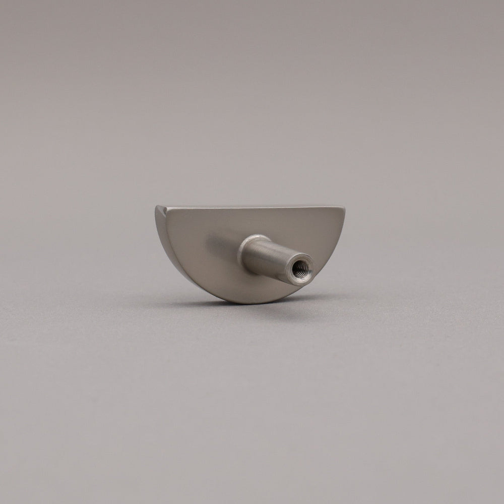 satin nickel silver half-circle half moon cabinet knob on gray background