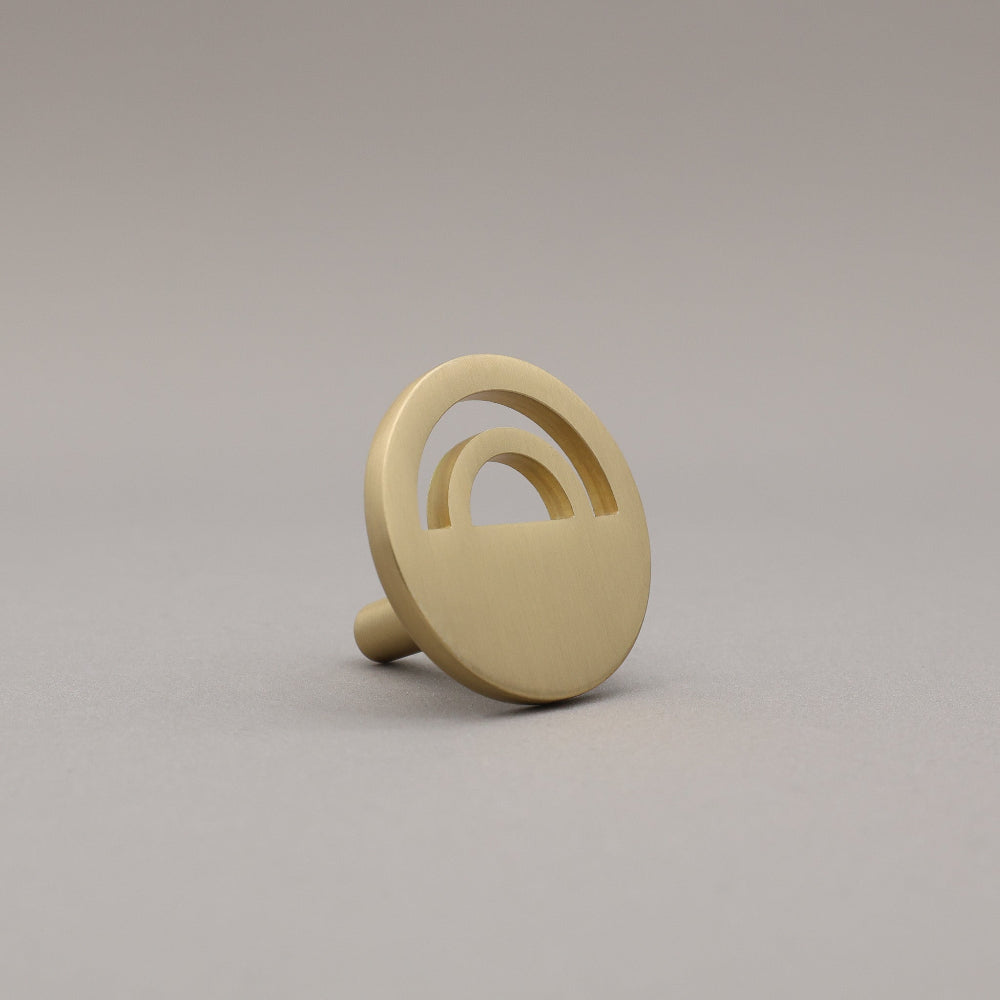 Horizon satin brass knob on gray background