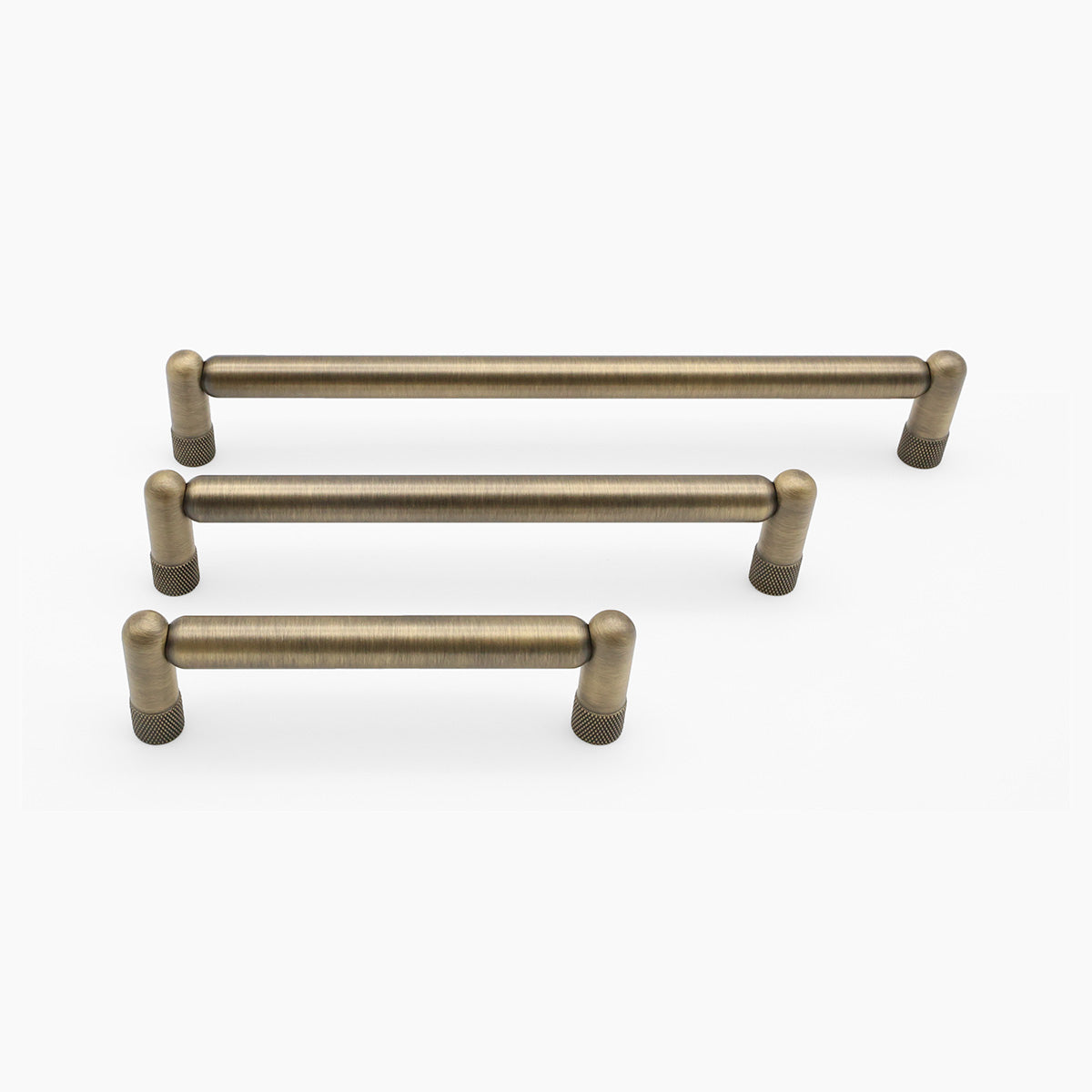 Set of three aged brass cabinet handles on a white background