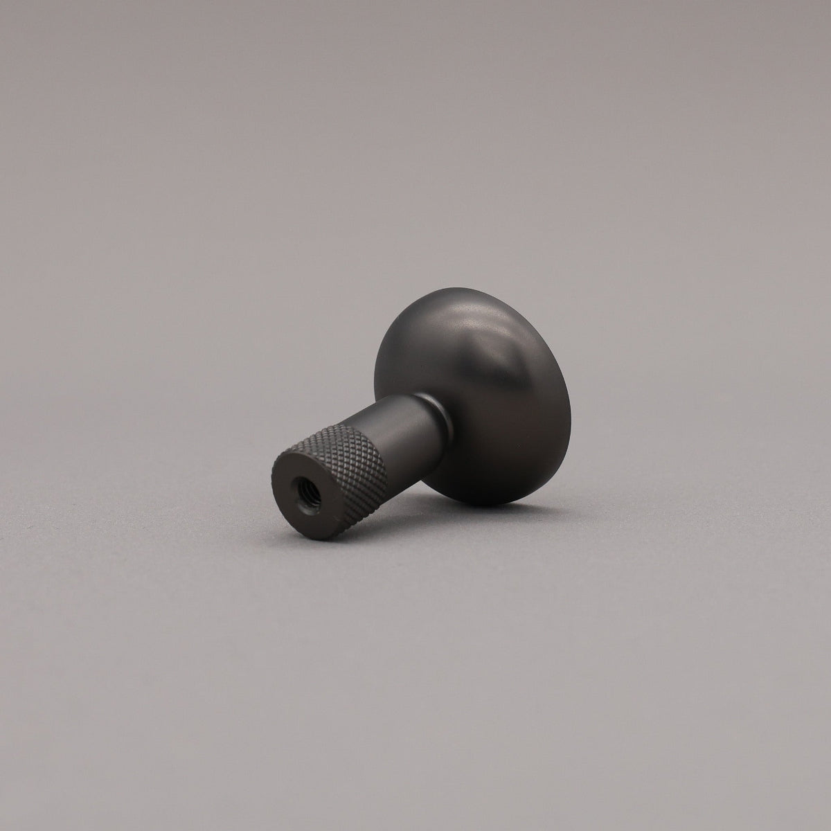 Black knob on a gray background