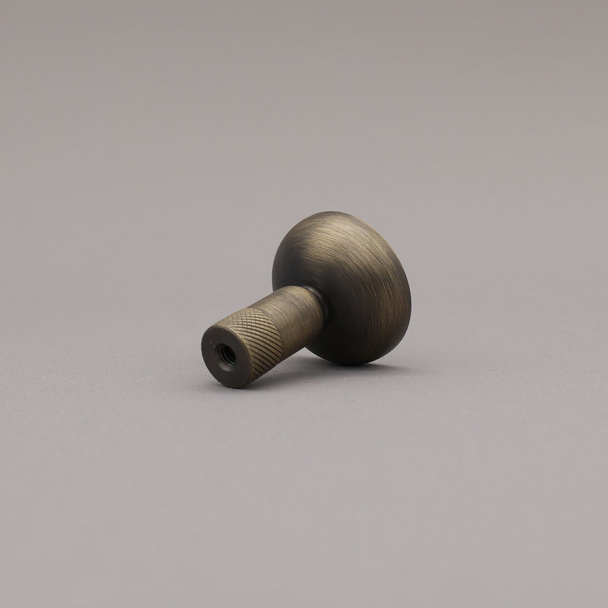 Bronze-colored knob on a gray background
