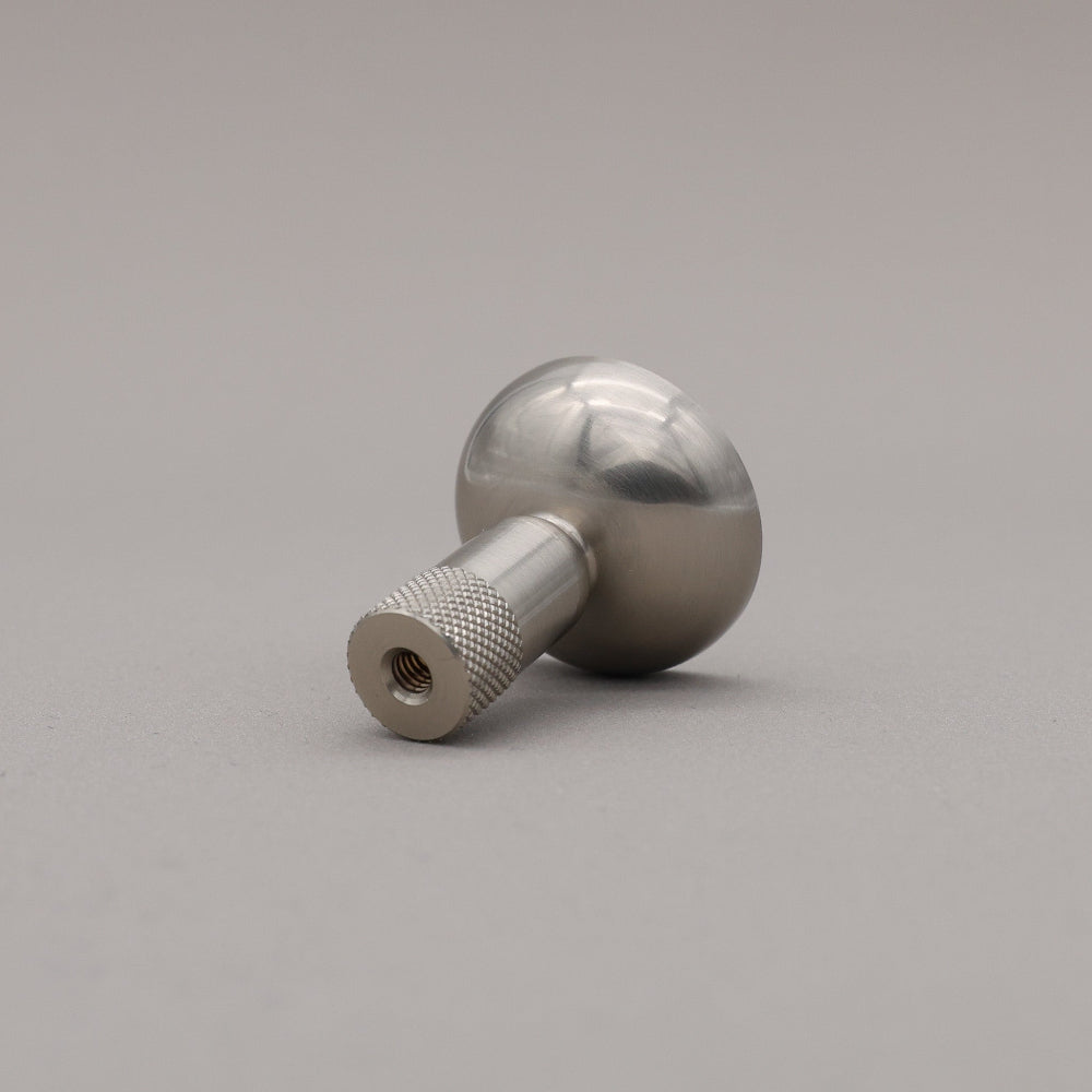 Metal knob on a gray background