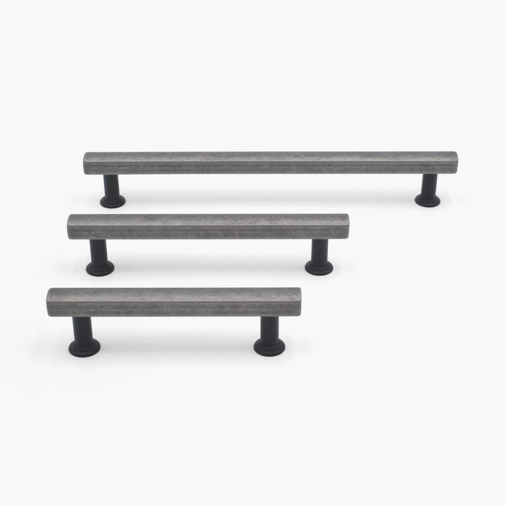 three mod cabinet pulls in weathered nickel and matte black in three sizes on white background