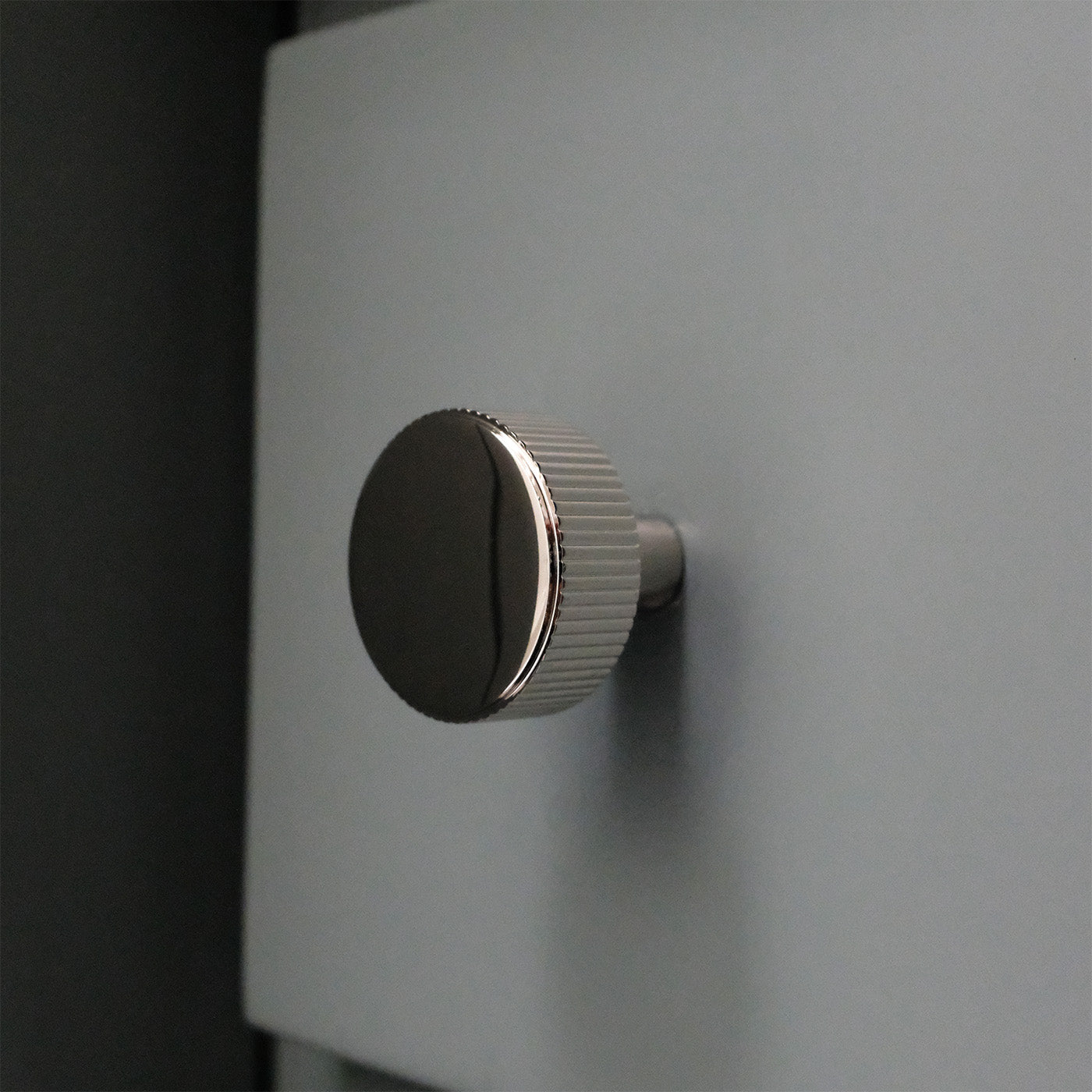Ribbed Polished Nickel Knob on Drawer.