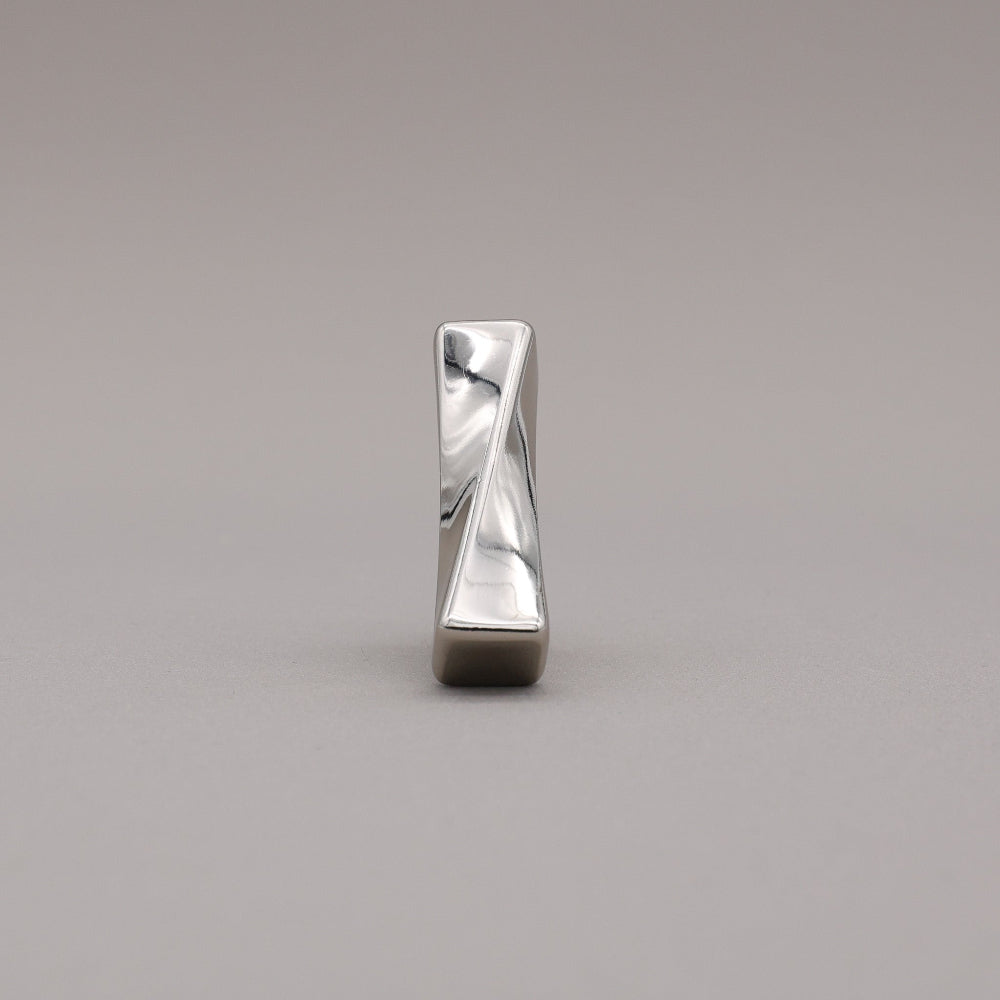 Polished nickel finished twist cabinet knob on gray background.
