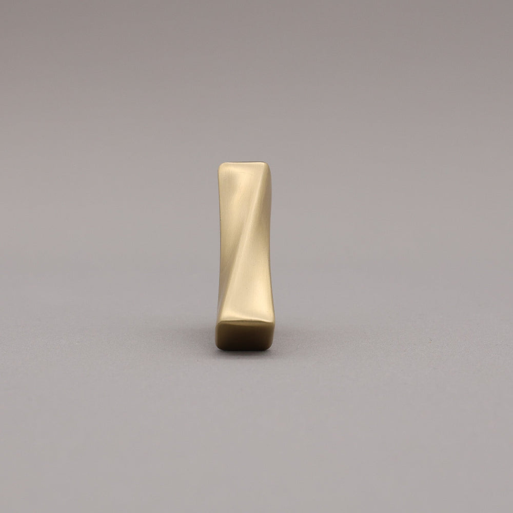 Satin Brass twisted knob on a gray background face forward.
