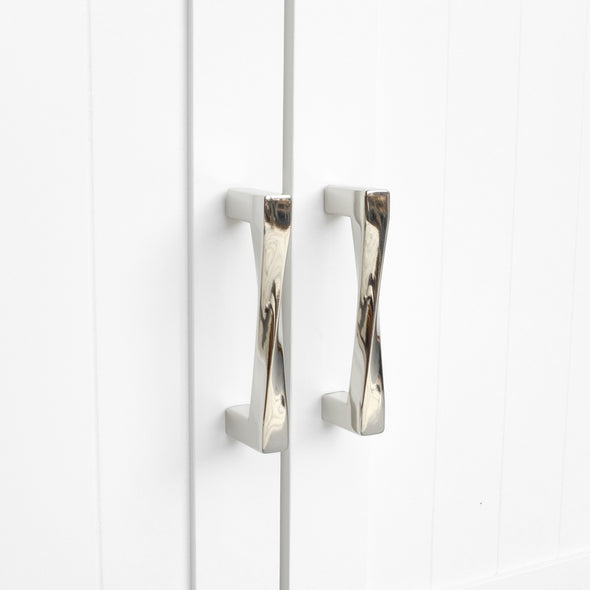 Polished nickel cabinet pulls on a white cabinet hickory hardware