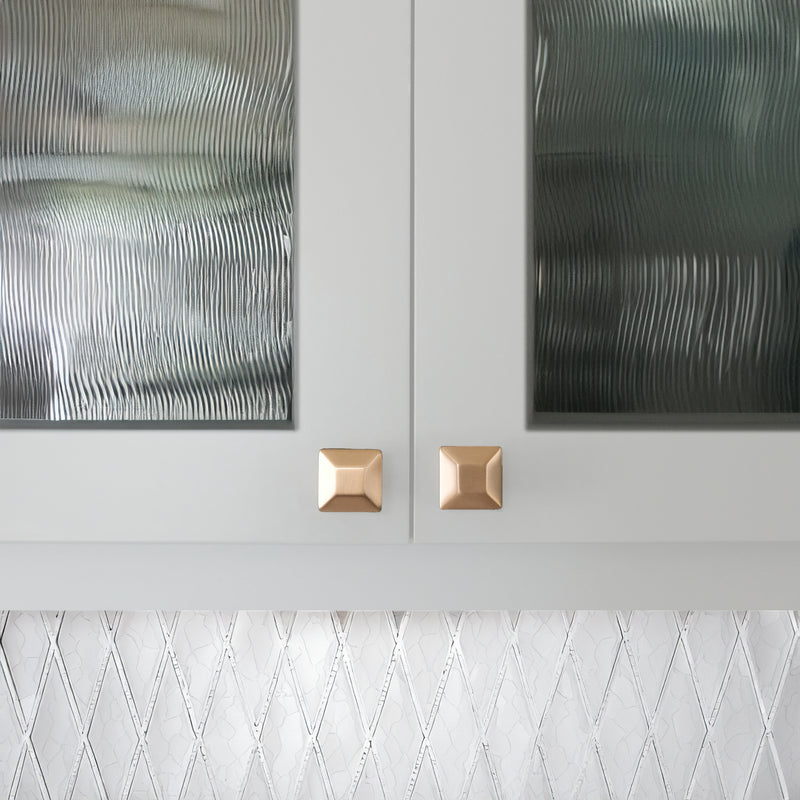 San Antonio Home with Gold Cabinet Knobs and white backsplash