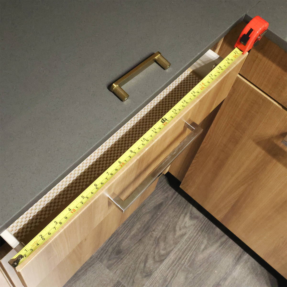 Cabinet Hardware Jig and Measuring Tape on Kitchen Counter