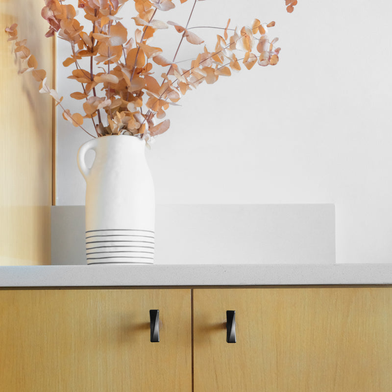 Black Twist Knob on Wooden Cabinets in Apartment