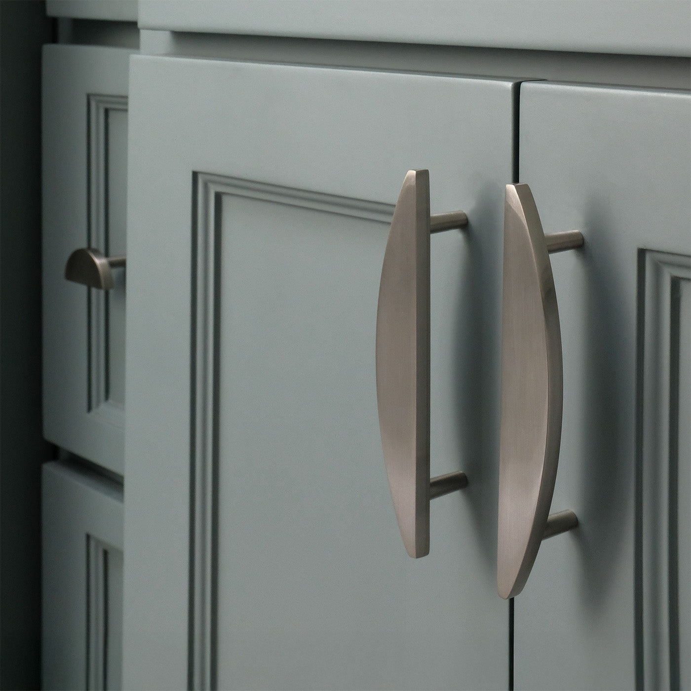 Satin nickel cabinet knob and pulls in blue bathroom.