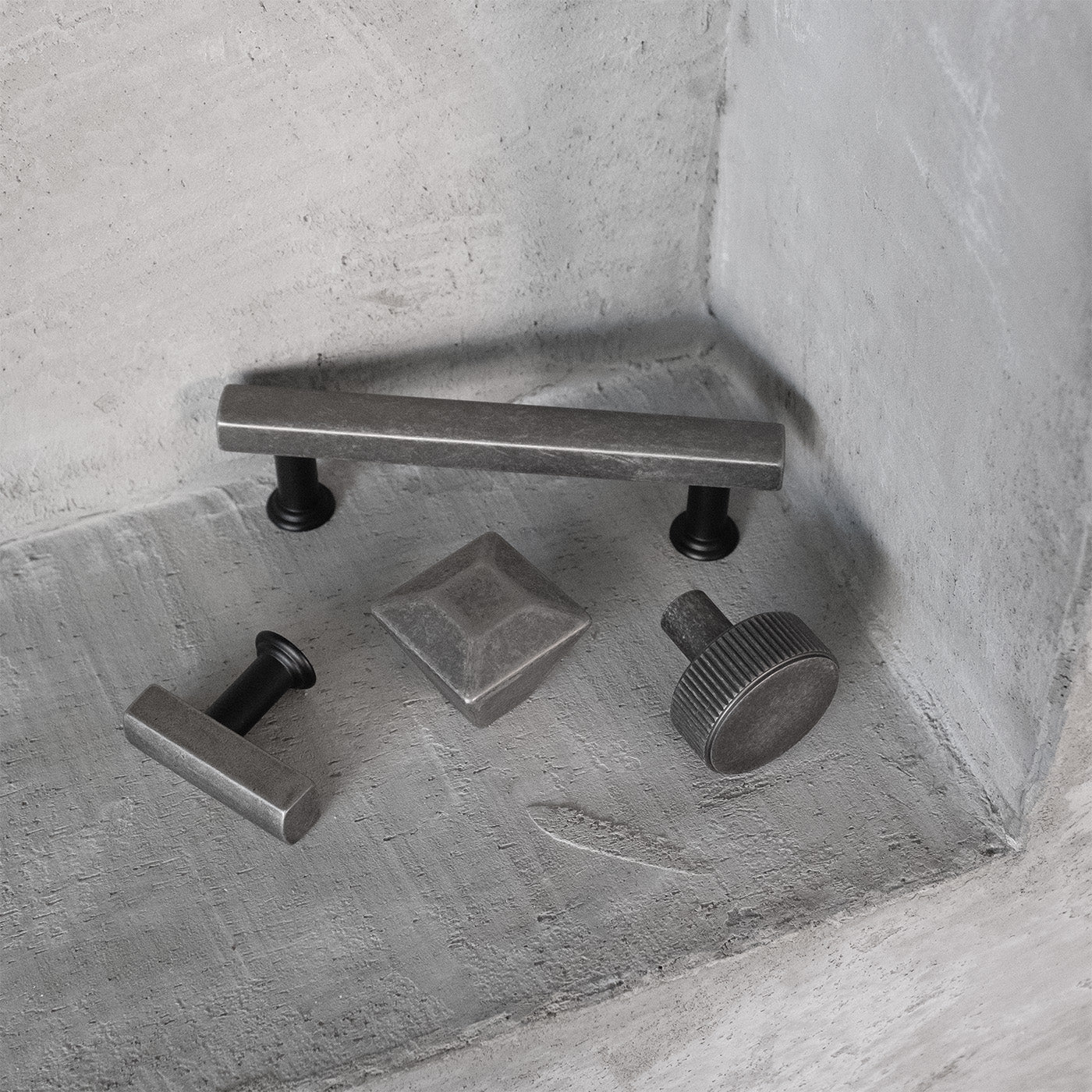 Weathered Nickel Knobs and Pulls on Concrete