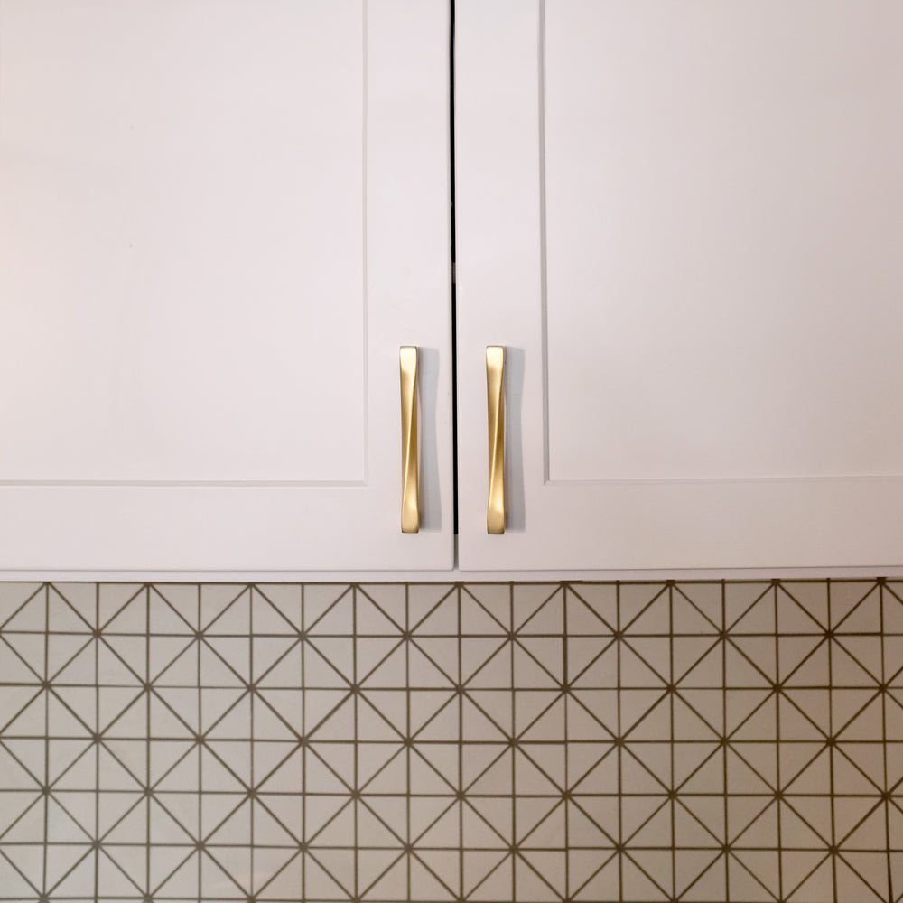 Gold Cabinet Pulls in the Kitchen with a geometric backsplash