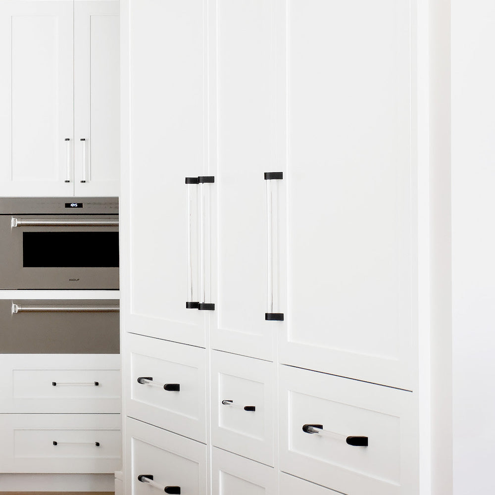 Black Appliance Pulls on White Refrigerator and White Drawers.