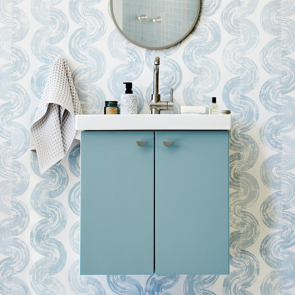 Black Knob on a Bathroom Vanity Drawer with a Satin Brass Faucet and a Mirror and Hand Towel