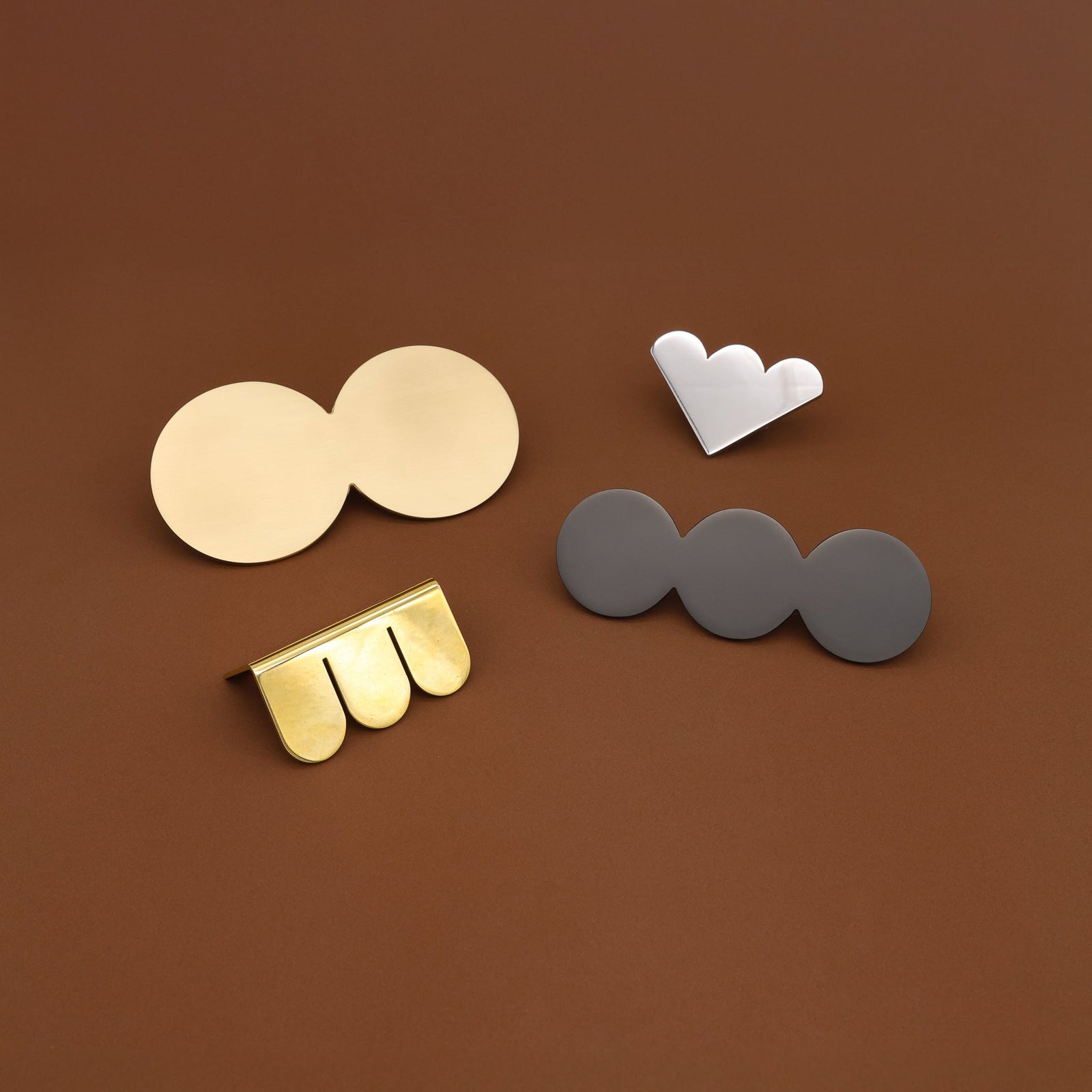 Circe Modern Whimsical Maxxxing Cabinet Hardware Solid Brass on Brown Background.