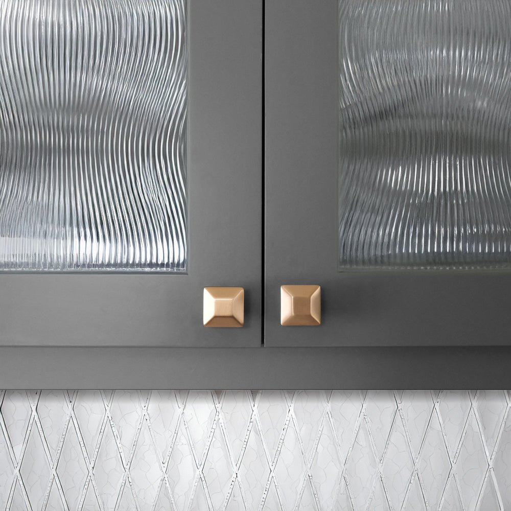 Solid Brass Diamone Shaped Cabinet Knobs on Gray cabinets with a White Backsplash