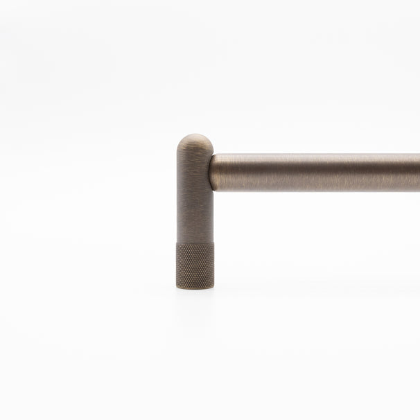 Knurled stem of appliance pull in antique english finish.