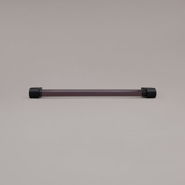 Clarity smoke acrylic and matte black stems 12 inch appliance pull laying on gray background