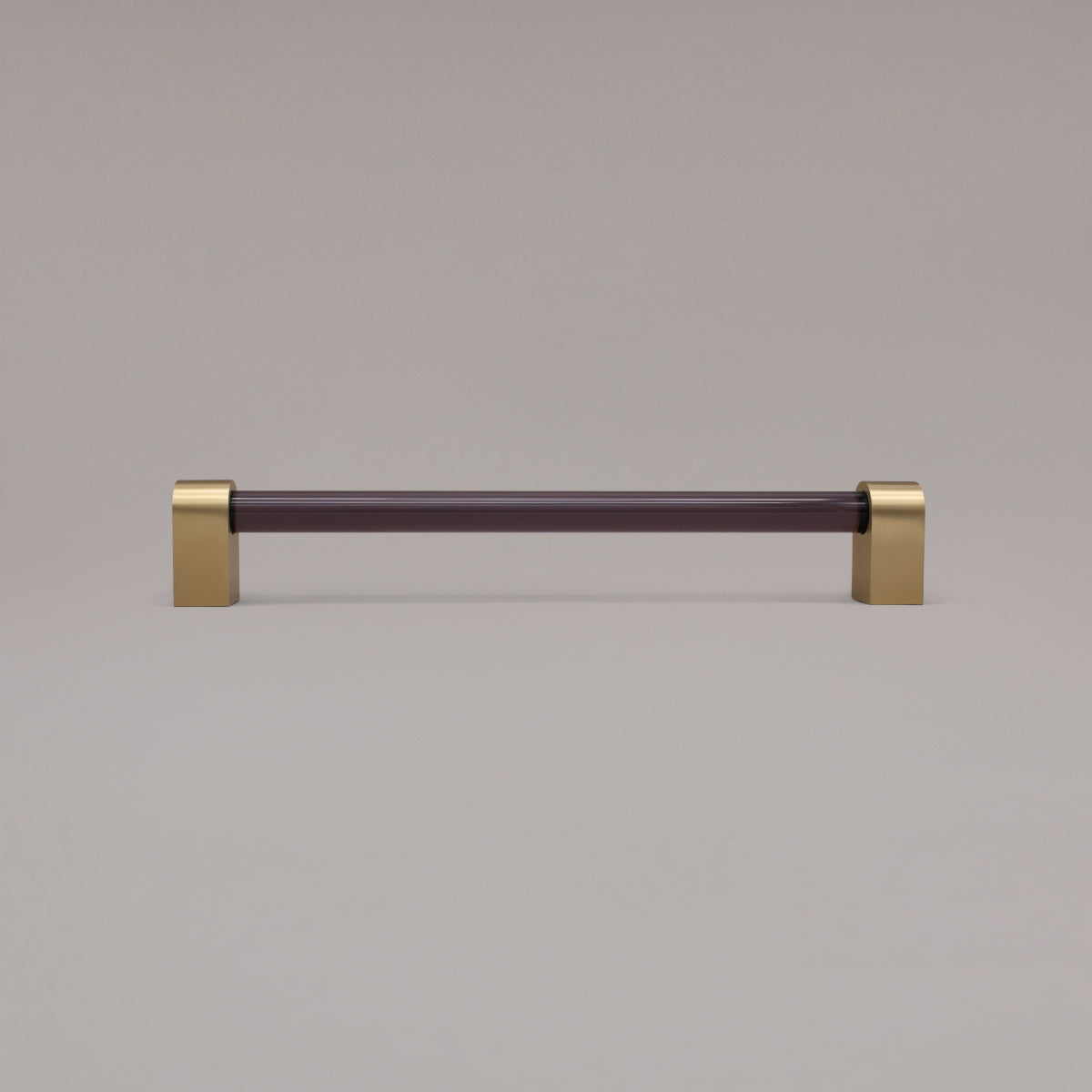 Clarity smoke acrylic and satin brass stems 12 inch appliance pull standing on gray background