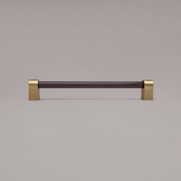 Clarity smoke acrylic and satin brass stems 12 inch appliance pull standing on gray background