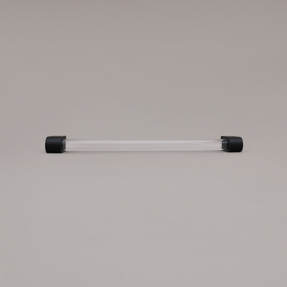 Clarity clear acrylic and matte black stems 12 inch appliance pull laying on gray background