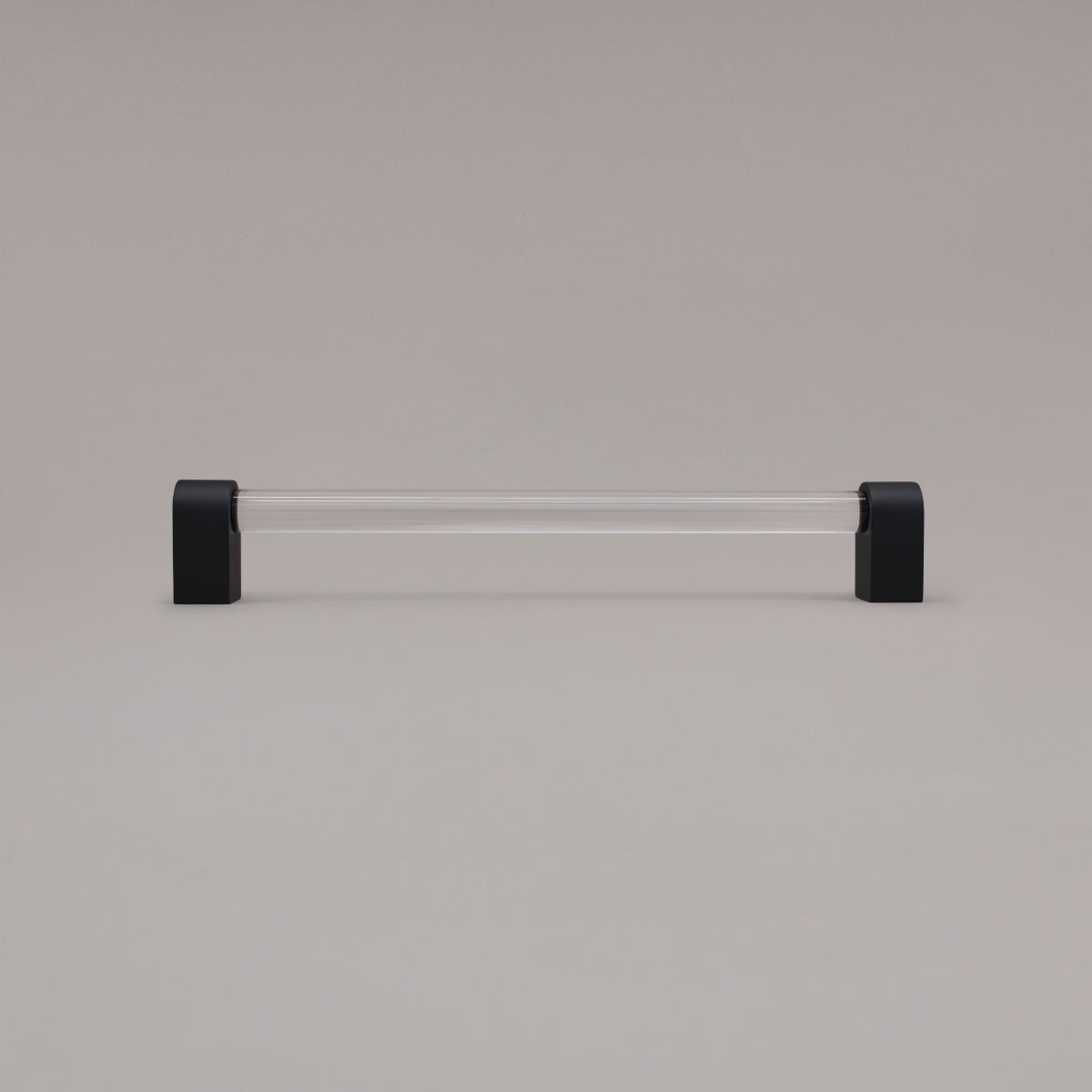 Clarity clear acrylic and matte black stems 12 inch appliance pull standing on gray background