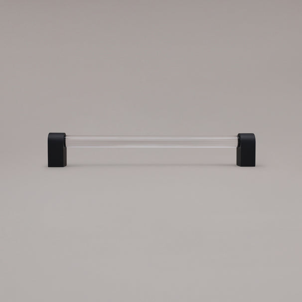 Clarity clear acrylic and matte black stems 12 inch appliance pull standing on gray background