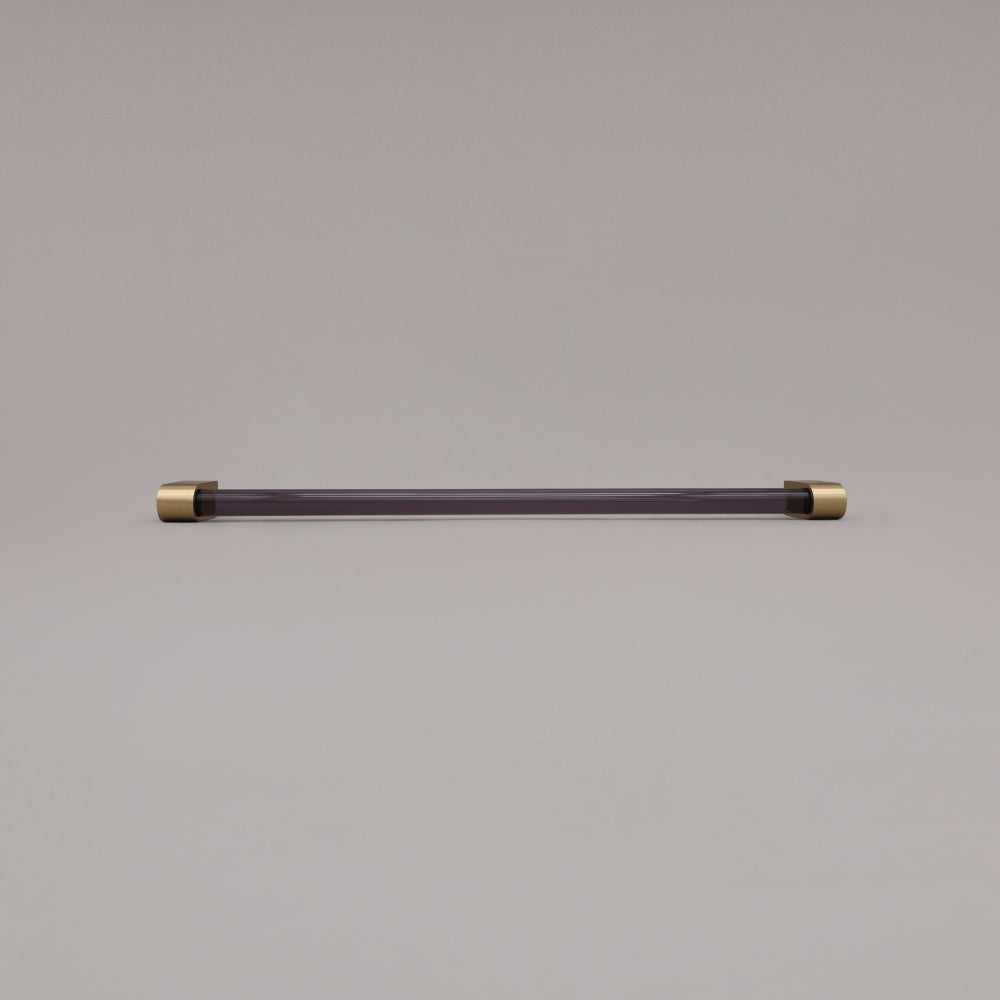 Clarity smoke acrylic and satin brass stems 18 inch appliance pull laying on gray background