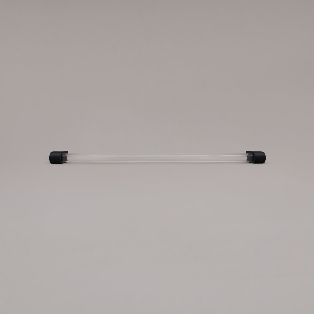 Clarity clear acrylic and matte black stems 18 inch appliance pull laying on gray background