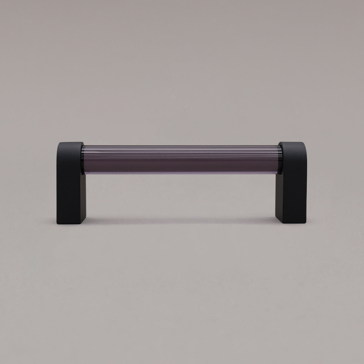 small smoke and matte black cabinet pull standing on gray background