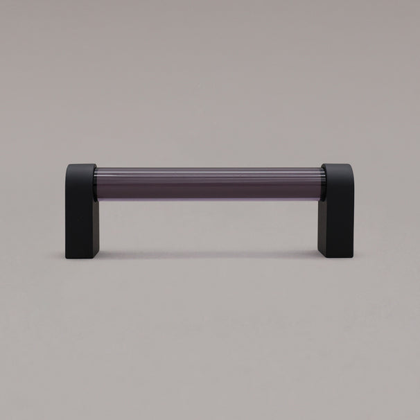 small smoke and matte black cabinet pull standing on gray background