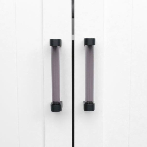 small smoke and matte black clarity pulls on white cabinet