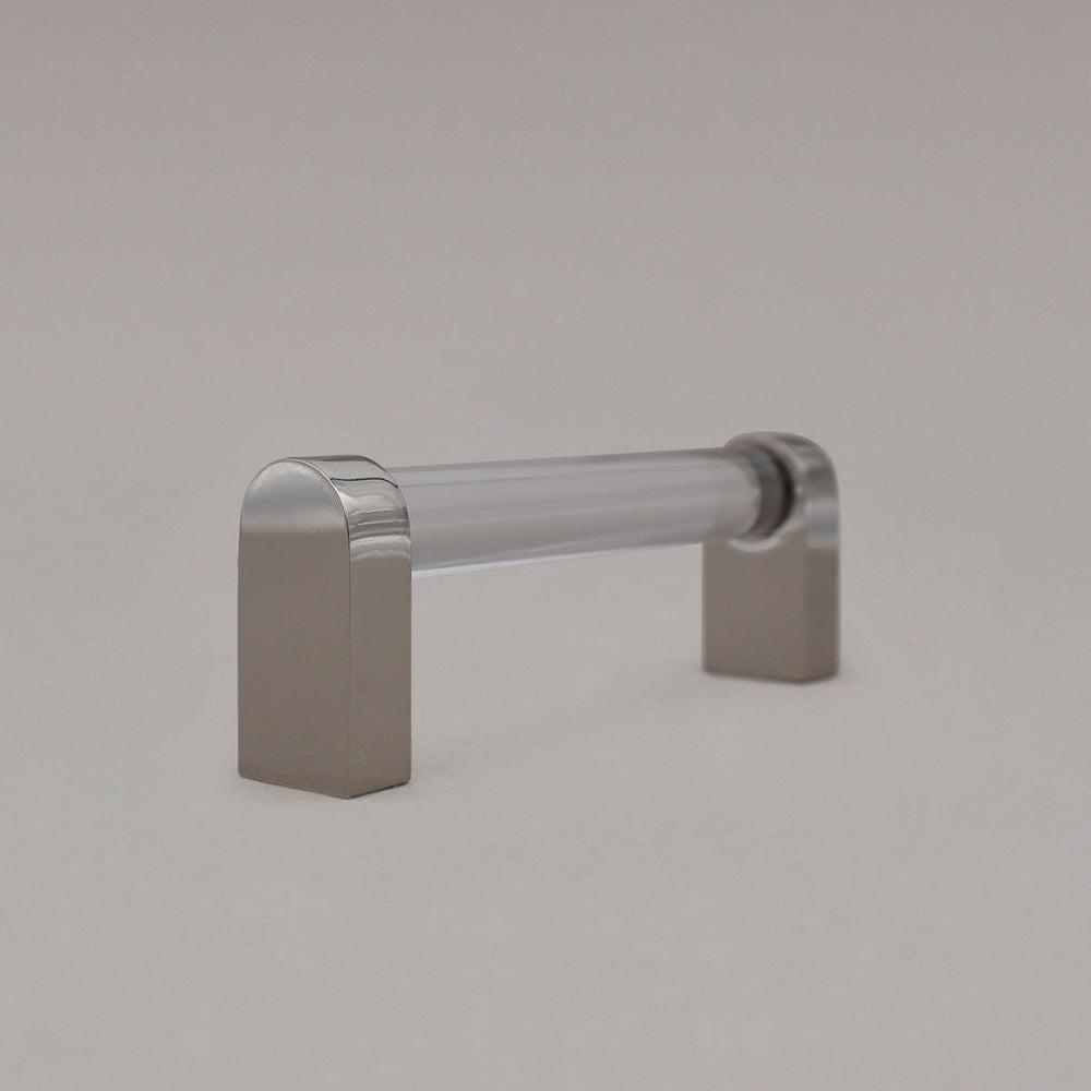 small clear and polished nickel cabinet pull standing sideways on gray background