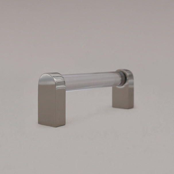 small clear and polished nickel cabinet pull standing sideways on gray background