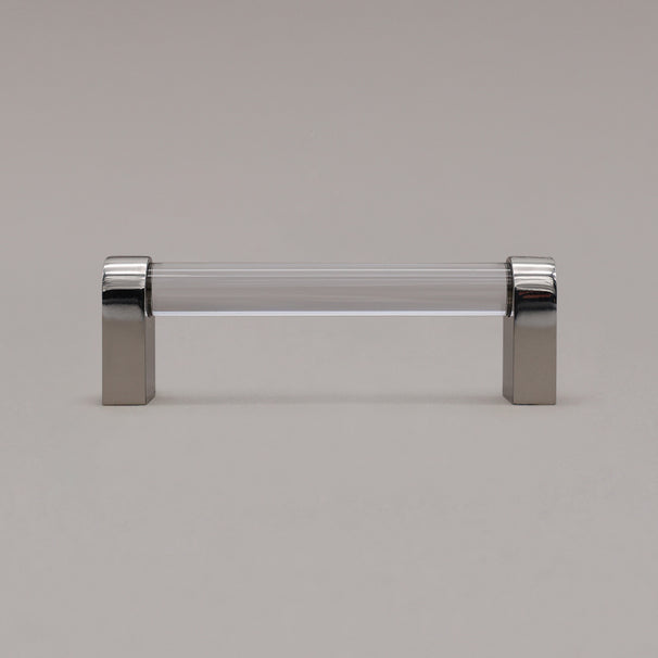 small clear and polished nickel cabinet pull standing on gray background