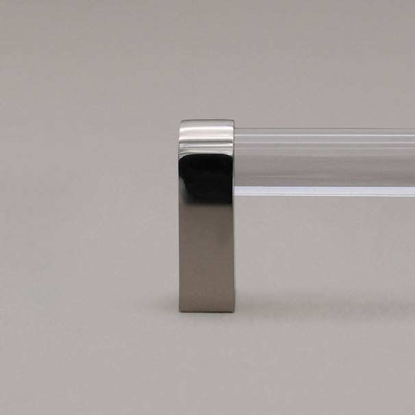 close up of clear and polished nickel cabinet pull stem on gray background