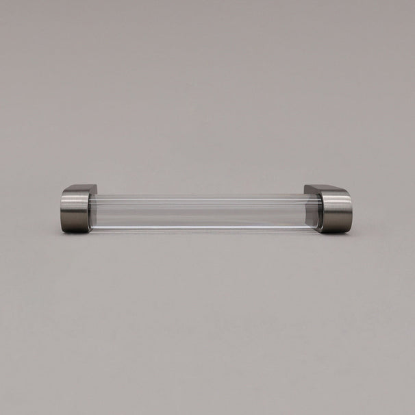 small clear and satin nickel cabinet pull laying on gray background