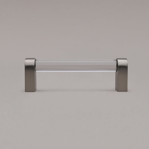 small clear and satin nickel cabinet pull standing on gray background