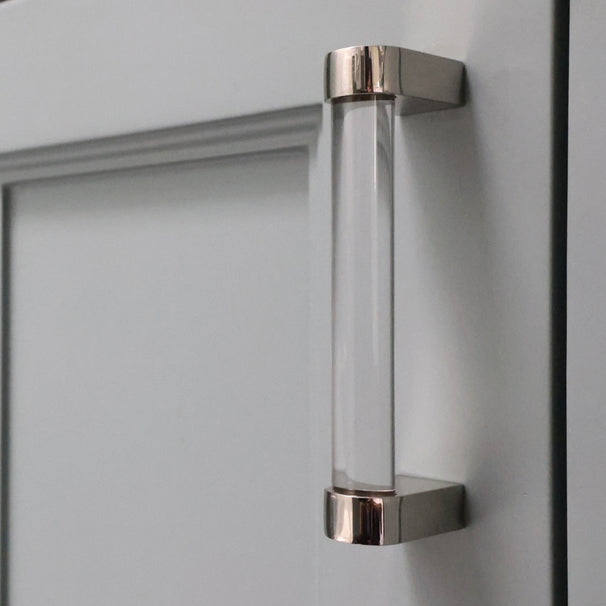 small clear and polished nickel cabinet pull installed on light cabinet