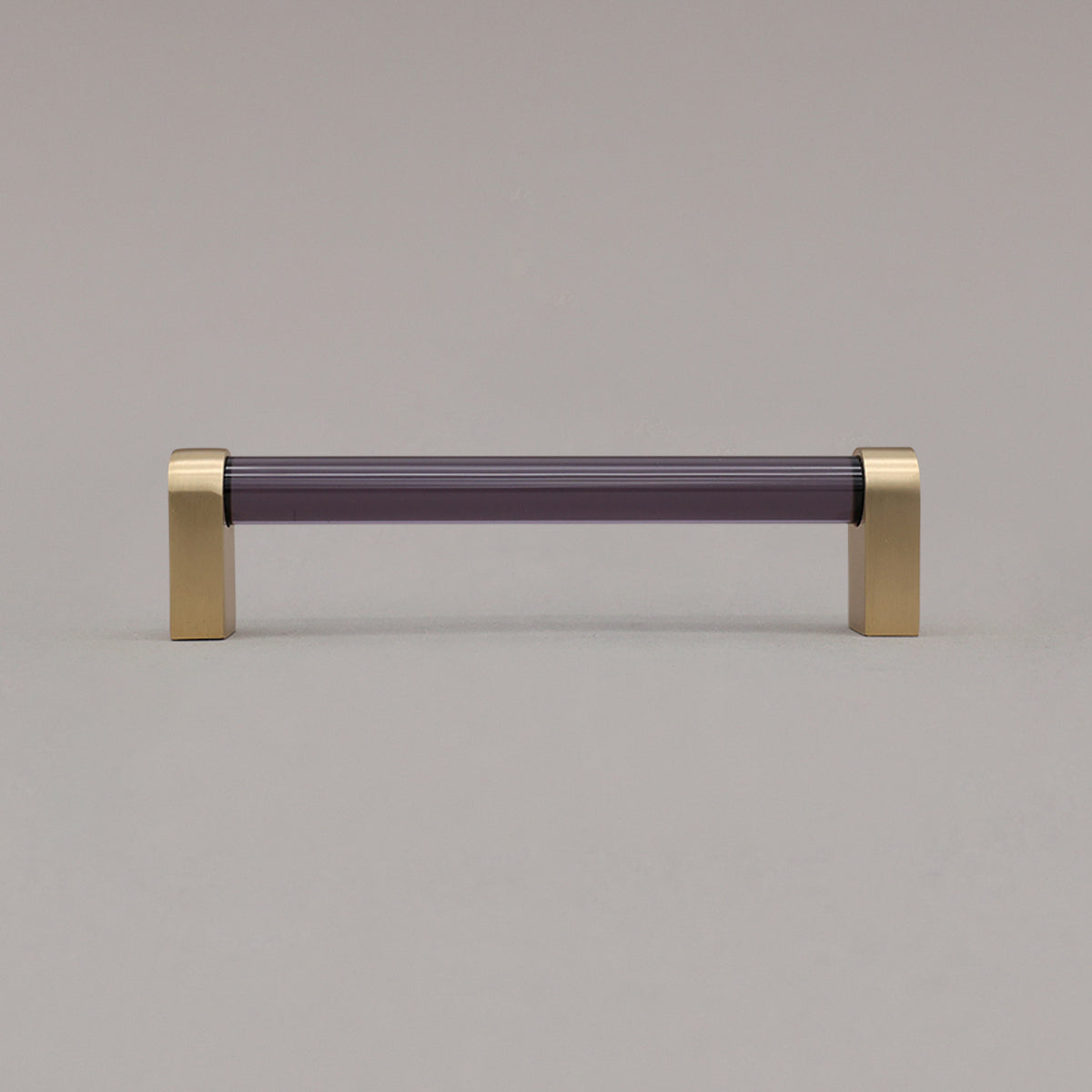 medium smoke and satin brass cabinet pull standing on gray background
