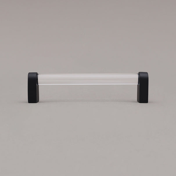 medium clear and matte black cabinet pull standing on gray background