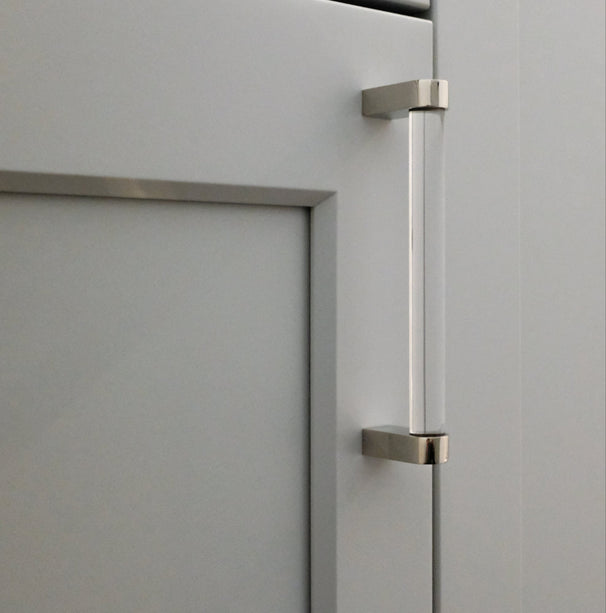 medium clear and polished nickel cabinet pull installed on light cabinet