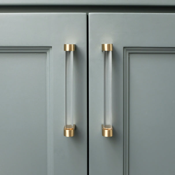 clarity satin brass cabinet pulls installed on blue cabinets