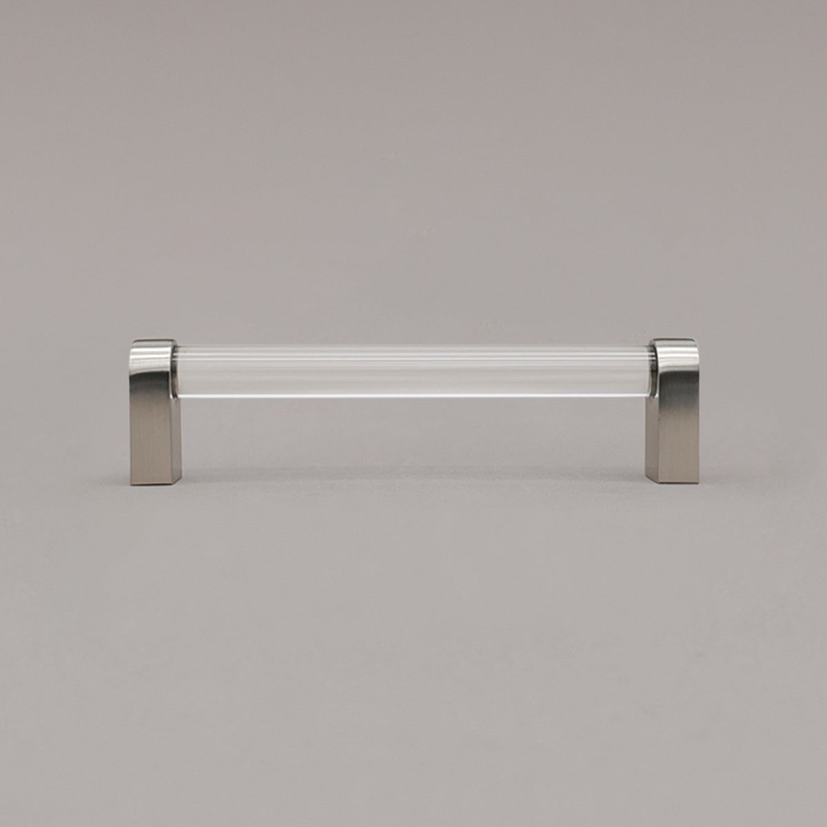 medium clear and satin nickel cabinet pull standing on gray background