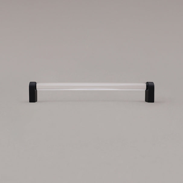 large clear and matte black cabinet pull standing on gray background